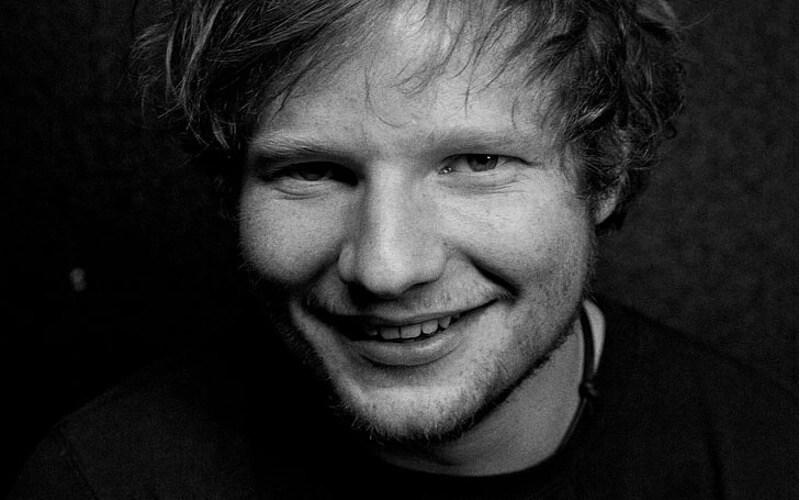 Black and white image of Ed Sheeran smiling.